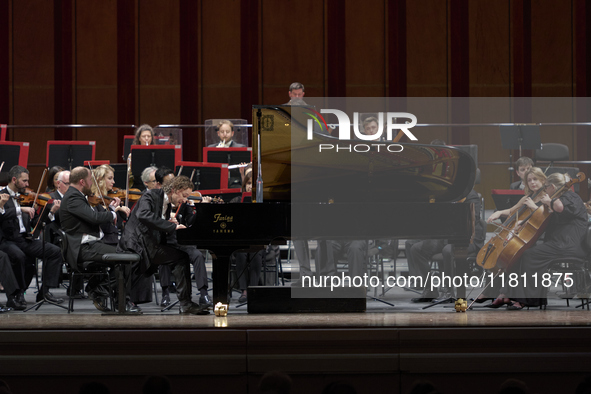 The London Philharmonic Orchestra, conducted by Alessandro Crudele, performs at the historic Teatro Petruzzelli in Bari, Italy, on November...