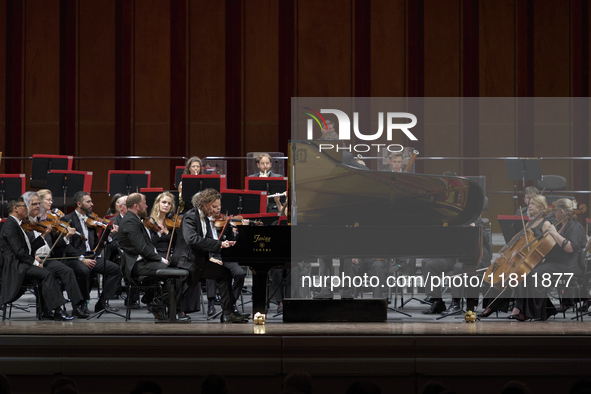 The London Philharmonic Orchestra, conducted by Alessandro Crudele, performs at the historic Teatro Petruzzelli in Bari, Italy, on November...