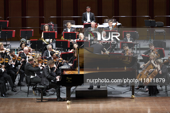 The London Philharmonic Orchestra, conducted by Alessandro Crudele, performs at the historic Teatro Petruzzelli in Bari, Italy, on November...