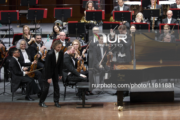 The London Philharmonic Orchestra, conducted by Alessandro Crudele, performs at the historic Teatro Petruzzelli in Bari, Italy, on November...