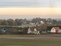 KRAKOW, POLAND - NOVEMBER 19:   
A small village with frozen fields and trees losing their leaves, seen from a train window as winter approa...