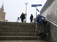 WARSAW, POLAND - NOVEMBER 19:   
An elderly lady walking up the stairs from an underground passage in front of Warsaw's Palace of Culture an...