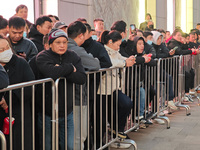 A large number of customers line up to buy new mobile phones outside Huawei's flagship store in Shanghai, China, on November 26, 2024. Some...