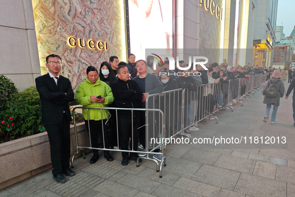 A large number of customers line up to buy new mobile phones outside Huawei's flagship store in Shanghai, China, on November 26, 2024. Some...