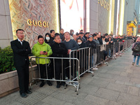 A large number of customers line up to buy new mobile phones outside Huawei's flagship store in Shanghai, China, on November 26, 2024. Some...