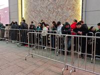 A large number of customers line up to buy new mobile phones outside Huawei's flagship store in Shanghai, China, on November 26, 2024. Some...