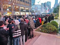 A large number of customers line up to buy new mobile phones outside Huawei's flagship store in Shanghai, China, on November 26, 2024. Some...