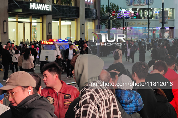 A large number of customers line up to buy new mobile phones outside Huawei's flagship store in Shanghai, China, on November 26, 2024. Some...