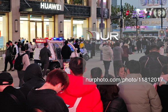 A large number of customers line up to buy new mobile phones outside Huawei's flagship store in Shanghai, China, on November 26, 2024. Some...