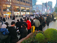 A large number of customers line up to buy new mobile phones outside Huawei's flagship store in Shanghai, China, on November 26, 2024. Some...