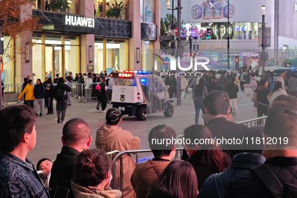 A large number of customers line up to buy new mobile phones outside Huawei's flagship store in Shanghai, China, on November 26, 2024. Some...