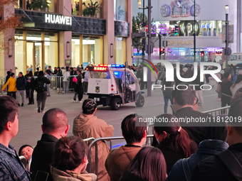 A large number of customers line up to buy new mobile phones outside Huawei's flagship store in Shanghai, China, on November 26, 2024. Some...