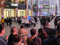 A large number of customers line up to buy new mobile phones outside Huawei's flagship store in Shanghai, China, on November 26, 2024. Some...