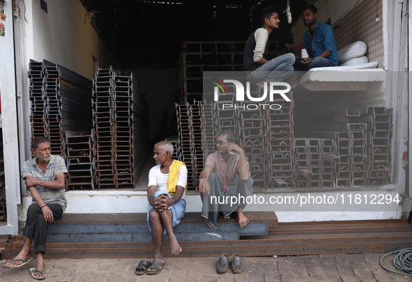 Labourers sit in a shop at a wholesale steel and iron market in Kolkata, India, on November 26, 2024. In November 2024, India's domestic iro...