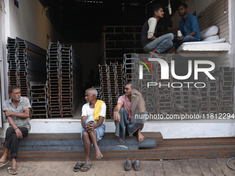 Labourers sit in a shop at a wholesale steel and iron market in Kolkata, India, on November 26, 2024. In November 2024, India's domestic iro...