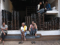 Labourers sit in a shop at a wholesale steel and iron market in Kolkata, India, on November 26, 2024. In November 2024, India's domestic iro...