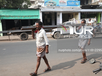 Labourers carry iron bars outside a shop at a steel and iron wholesale market in Kolkata, India, on November 26, 2024. In November 2024, Ind...