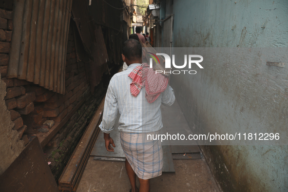 Labourers carry iron bars outside a shop at a steel and iron wholesale market in Kolkata, India, on November 26, 2024. In November 2024, Ind...