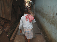 Labourers carry iron bars outside a shop at a steel and iron wholesale market in Kolkata, India, on November 26, 2024. In November 2024, Ind...