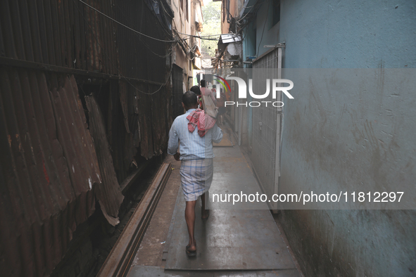 Labourers carry iron bars outside a shop at a steel and iron wholesale market in Kolkata, India, on November 26, 2024. In November 2024, Ind...