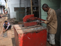 Labourers work with iron outside a shop at a steel and iron wholesale market in Kolkata, India, on November 26, 2024. In November 2024, Indi...