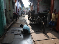 A laborer cuts an iron plate outside a shop at a steel and iron wholesale market in Kolkata, India, on November 26, 2024. In November 2024,...