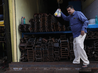 A trader comes out from his shop at a wholesale steel and iron market in Kolkata, India, on November 26, 2024. In November 2024, India's dom...