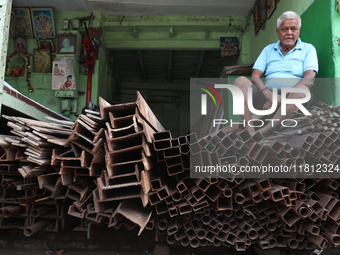 A trader sits inside his shop at a wholesale steel and iron market in Kolkata, India, on November 26, 2024. In November 2024, India's domest...