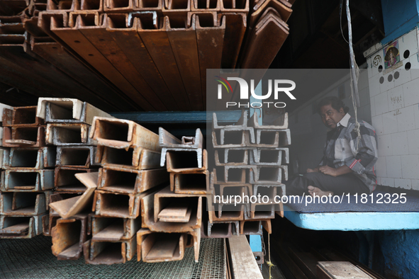 A trader sits inside his shop at a wholesale steel and iron market in Kolkata, India, on November 26, 2024. In November 2024, India's domest...