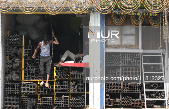 A laborer comes out from a shop at a wholesale steel and iron market in Kolkata, India, on November 26, 2024. In November 2024, India's dome...