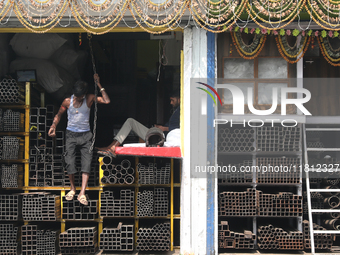 A laborer comes out from a shop at a wholesale steel and iron market in Kolkata, India, on November 26, 2024. In November 2024, India's dome...