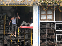 A laborer comes out from a shop at a wholesale steel and iron market in Kolkata, India, on November 26, 2024. In November 2024, India's dome...