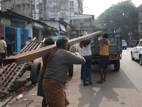 Labourers carry iron bars to load onto a truck at a steel and iron wholesale market in Kolkata, India, on November 26, 2024. In November 202...