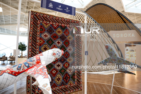 Models of planes and Azerbaijan traditional carpet are seen in Heydar Aliyev Airport in Baku, the capital of Azerbaijan on November 26, 2024...