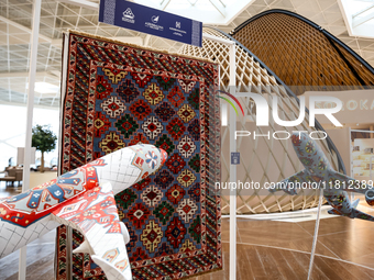 Models of planes and Azerbaijan traditional carpet are seen in Heydar Aliyev Airport in Baku, the capital of Azerbaijan on November 26, 2024...