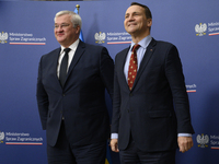 Poland's Minister of Foreign Affairs, Radoslaw Sikorski (R), welcomes Ukraine's Foreign Affairs Minister, Andrii Sybiha (L), before a press...