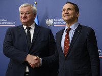 Poland's Minister of Foreign Affairs Radoslaw Sikorski (right) shakes hands with Ukraine's Foreign Affairs Minister Andrii Sybiha (left) bef...