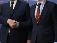 Poland's Minister of Foreign Affairs Radoslaw Sikorski (right) shakes hands with Ukraine's Foreign Affairs Minister Andrii Sybiha (left) bef...