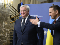 Poland's Minister of Foreign Affairs, Radoslaw Sikorski (R), welcomes Ukraine's Foreign Affairs Minister, Andrii Sybiha (L), before a press...