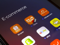 The e-commerce services Shopee, Temu, Alibaba, Shopify, eBay, and Mercado Libre apps appear on the screen of a smartphone in Reno, United St...