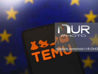 The Temu logo appears on the screen of a smartphone with the flag of the European Union (EU) in the background in Reno, United States, on No...