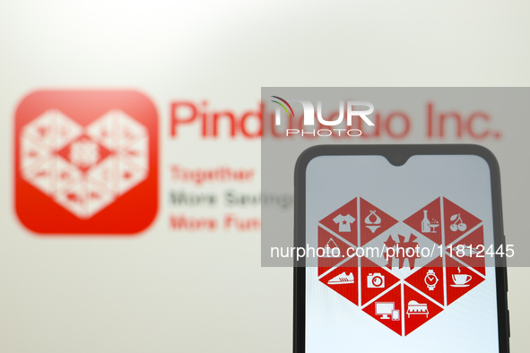 The Pinduoduo logo appears on the screen of a smartphone and in the background on a computer screen in Reno, United States, on November 26,...