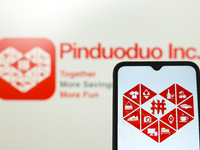 The Pinduoduo logo appears on the screen of a smartphone and in the background on a computer screen in Reno, United States, on November 26,...