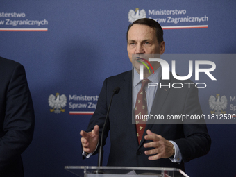 Poland's Minister of Foreign Affairs Radoslaw Sikorski gestures as he takes part in a press conference after talks with his Ukrainian counte...