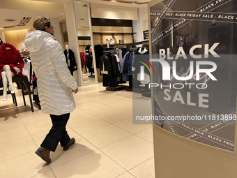 Signs for Black Friday sales are in stores at a shopping mall in Toronto, Ontario, Canada, on November 26, 2024 (