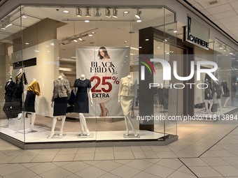 Signs for Black Friday sales are in stores at a shopping mall in Toronto, Ontario, Canada, on November 26, 2024 (