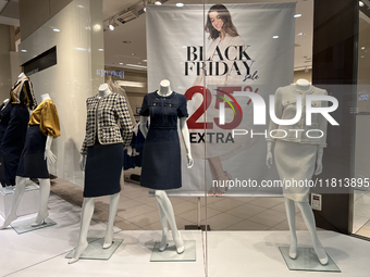 Signs for Black Friday sales are in stores at a shopping mall in Toronto, Ontario, Canada, on November 26, 2024 (