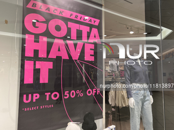 Signs for Black Friday sales are in stores at a shopping mall in Toronto, Ontario, Canada, on November 26, 2024 (