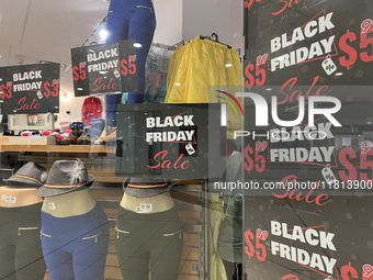 Signs for Black Friday sales are in stores at a shopping mall in Toronto, Ontario, Canada, on November 26, 2024 (