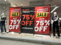 Signs for Black Friday sales are in stores at a shopping mall in Toronto, Ontario, Canada, on November 26, 2024 (